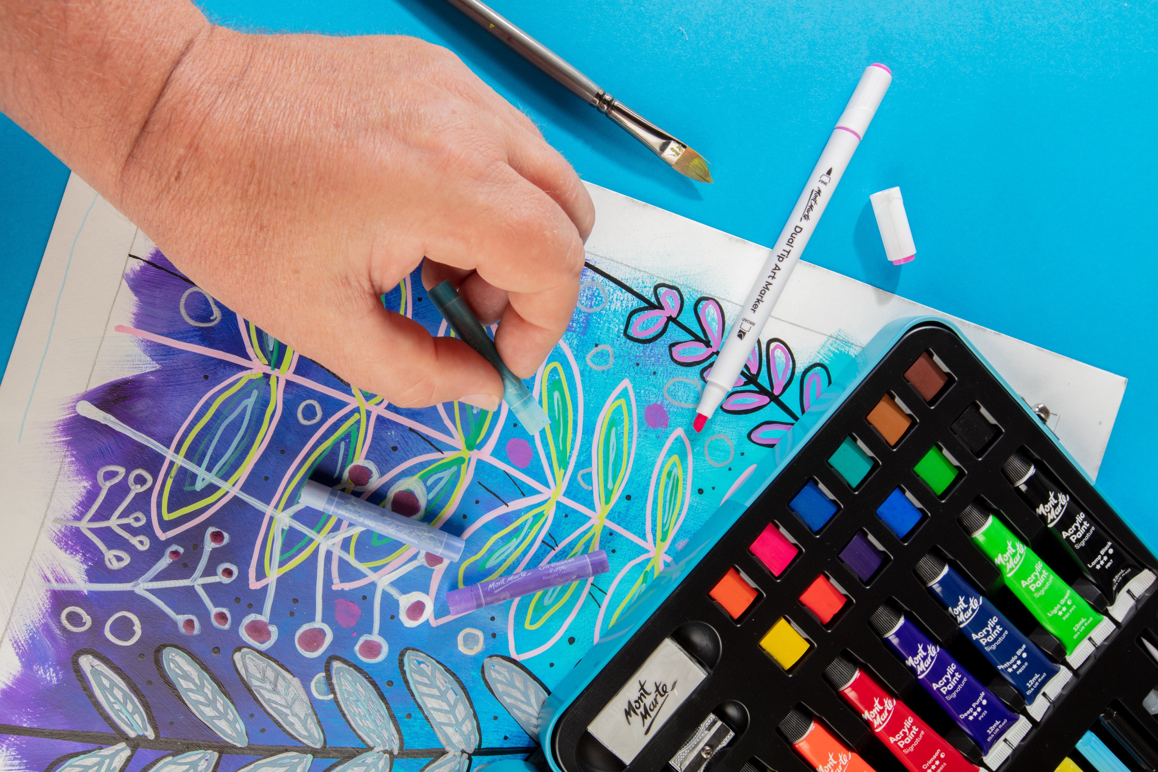 Hand drawing on a mixed media underwater piece with oil pastels